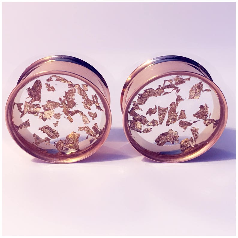 ear guages. ear plugs ear stretchers Gold flake plugs