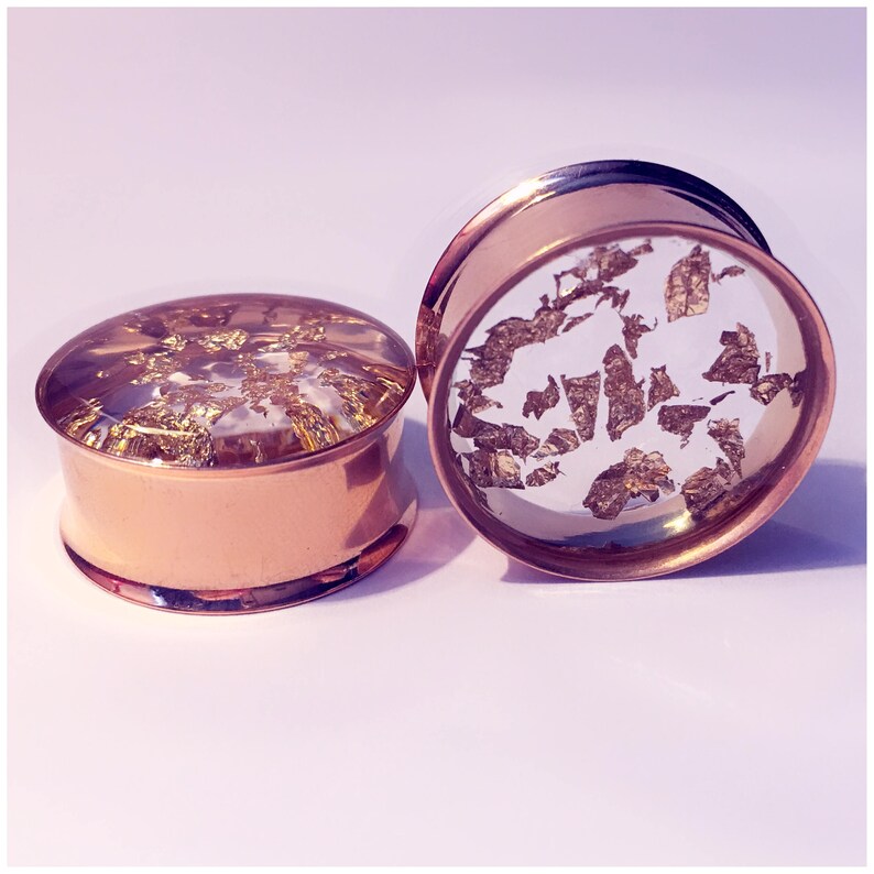 ear guages. ear plugs ear stretchers Gold flake plugs