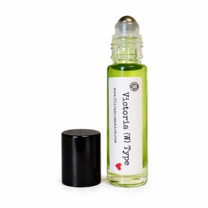 May include: A clear glass roll-on bottle filled with light green liquid, featuring a silver roller ball and a black cap. The white label displays the text Victoria (W) Type, a small lion icon, a red heart, and the website www.UltraAromatics.com.