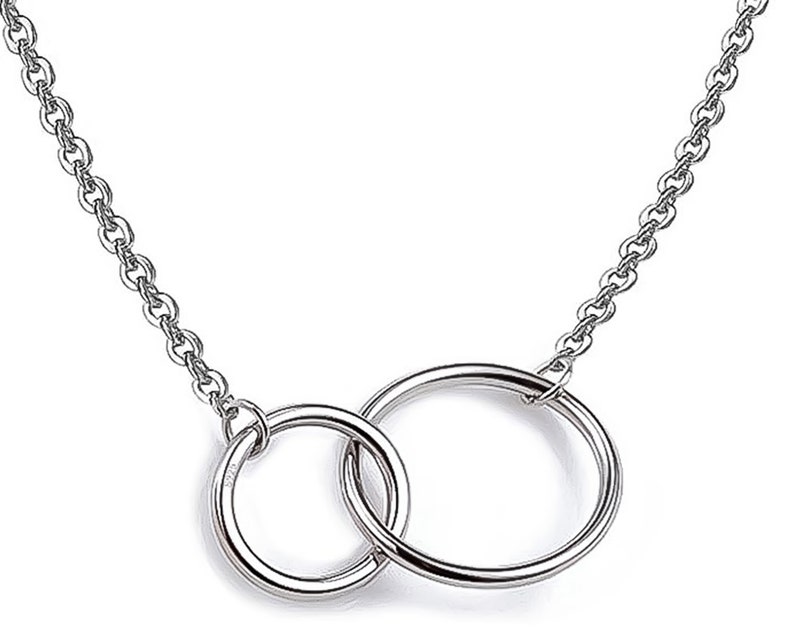 May include: A silver chain necklace with a double circle pendant.