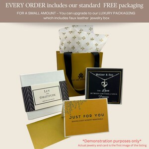 May include: A yellow gift bag with a white tissue paper lining. The bag is filled with a small white box with a black and white chevron pattern and the words "LUV and GRATITUDE". There is also a black card with a silver necklace and the words "Mother & Son" and "The Love Between a Mother & Son is Forever". A yellow card with green leaves and the words "JUST FOR YOU" and "MAKING EVERY MOMENT MEMORABLE" is also included. The text "*Demonstration purposes only*" and "Actual jewelry and card is the first image of the listing" is at the bottom of the image.