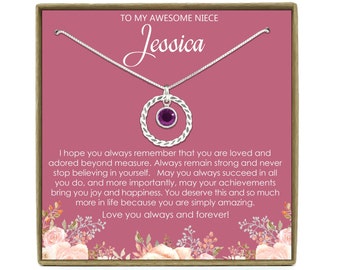 May include: A pink gift box with a silver necklace and a purple gemstone pendant. The box has a message that reads "To my awesome niece Jessica. I hope you always remember that you are loved and adored beyond measure. Always remain strong and never stop believing in yourself. May you always succeed in all you do, and more importantly, may your achievements bring you joy and happiness. You deserve this and so much more in life because you are simply amazing. Love you always and forever!"
