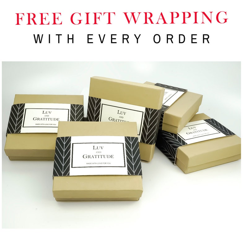 May include: A stack of brown gift boxes with black and white chevron patterned paper and a white label that says "LUV AND GRATITUDE" on each box. Free gift wrapping with every order.