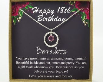 May include: A silver necklace with a pink crystal in a circle pendant, presented in a gift box with a message that reads "Happy 18th Birthday Bernadette. You have grown into an amazing young woman! Beautiful inside and out, smart and pretty. You are a gift to all who know you. Best wishes as you celebrate your big day! Love you always and forever."