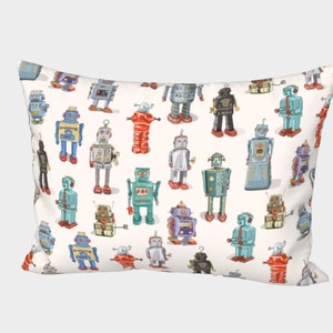 May include: A white pillow with a pattern of colorful vintage robots. The robots are in various poses and have different designs.