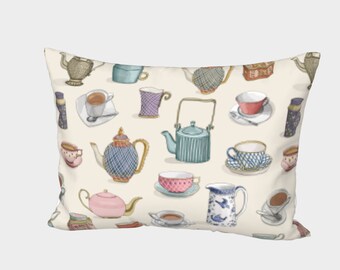 May include: A cream-colored pillow with a pattern of teapots and teacups in various colors and designs. The pattern includes blue, green, pink, and purple teapots and cups.