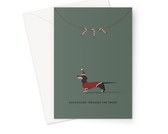 Carte de Noël noire et tan dachshund avec des cannes de sucrerie