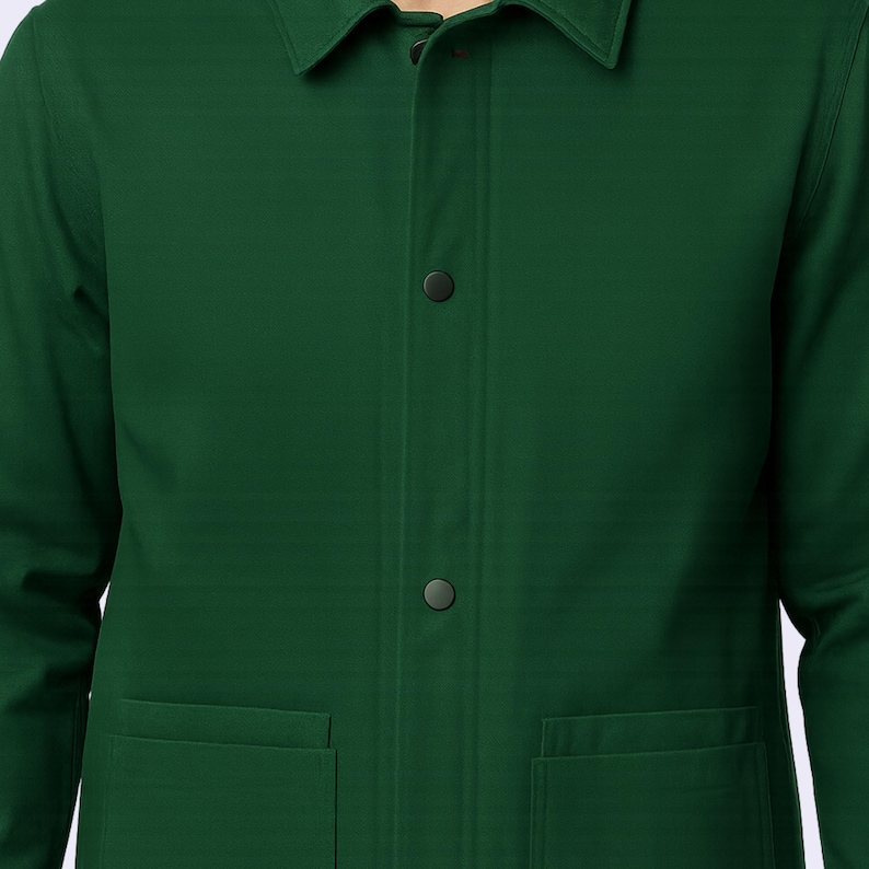 May include: A dark green jacket with a collar, two front pockets, and two visible buttons. The jacket is made of a smooth fabric and has a classic design. The jacket is a solid color and appears to be a medium weight.