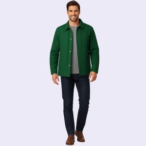 May include: A person wearing a green jacket over a gray t-shirt and dark blue jeans. The jacket has a button-down front and a collared neckline. The person is also wearing brown shoes.