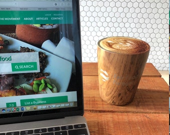 Double walled stainless steel coffee travel cup with a silicone lid.