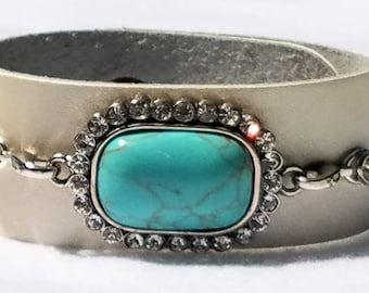 Turquoise Colored Centerpiece with Crystal Accents on a Leather Cuff Bracelet • Metallic Cream Colored Leather Cuff Bracelet with Crystals