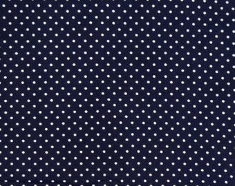 May include: A navy blue fabric with a white polka dot pattern.