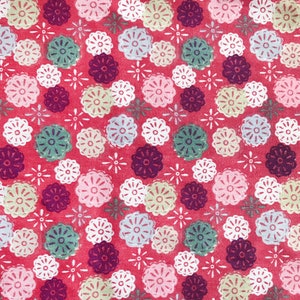 May include: A red fabric with a repeating pattern of white, pink, and green stylised flowers. The flowers are outlined in white and have a textured appearance.