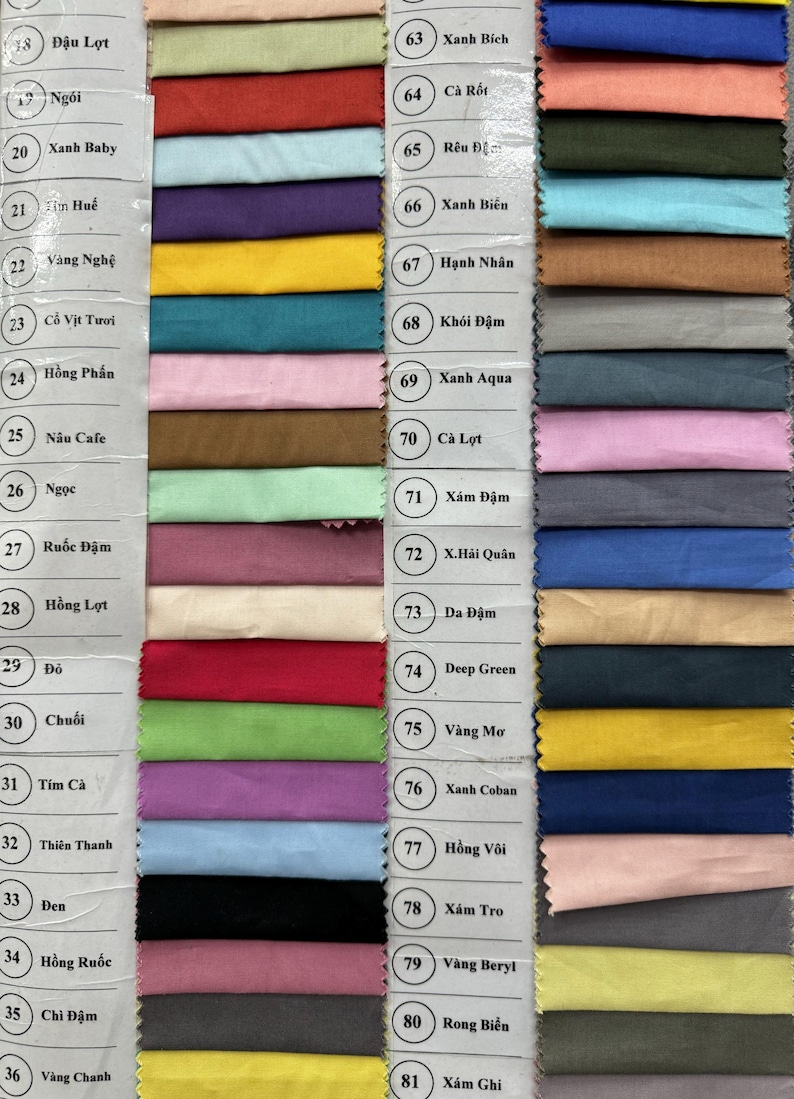 May include: A fabric swatch color chart featuring a wide array of rectangular textile samples arranged in columns. Each swatch is labeled with a corresponding number and text identifier, showcasing a diverse palette of solid colors including reds, blues, greens, yellows, pinks, browns, and grays.