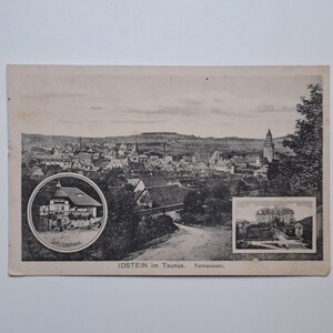 May include: A vintage black and white postcard depicting Idstein im Taunus, Germany. The postcard shows a townscape and includes inset images of buildings. Text on the card reads "Schützenhaus" and "Schloss".
