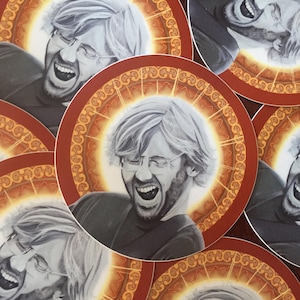 May include: A set of five round stickers featuring black and white portraits of men with a white background and a gold and red circular design around the portraits.