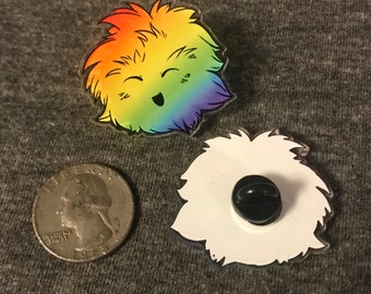 May include: Two rainbow-colored fuzzy pins with a smiling face. The pins are about the size of a quarter. The back of the pins are white with a black pin back.