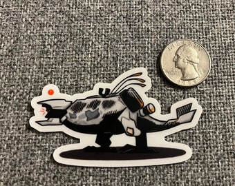 May include: A black and white cartoon sticker of a spaceship with a red light on the front. The spaceship is on a black background.