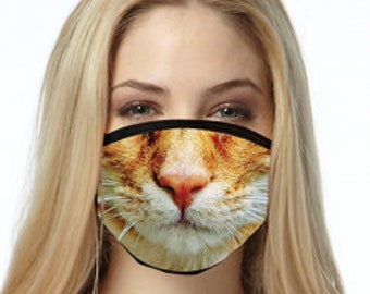 May include: A close-up of a face mask with a printed image of a ginger cat's face. The mask has a black elastic band and a black nose wire.