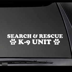 May include: White vinyl decal with the text "SEARCH & RESCUE K-9 UNIT" and two paw prints on either side of the text.