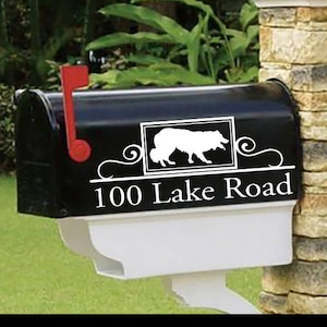 May include: Black mailbox with a white silhouette of a dog and the text "100 Lake Road" in white.