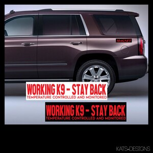 May include: Two red and white magnetic signs that say "WORKING K9 - STAY BACK TEMPERATURE CONTROLLED AND MONITORED" on a dark brown SUV. The word "MAGNET" is printed in red on the top right corner of the SUV.