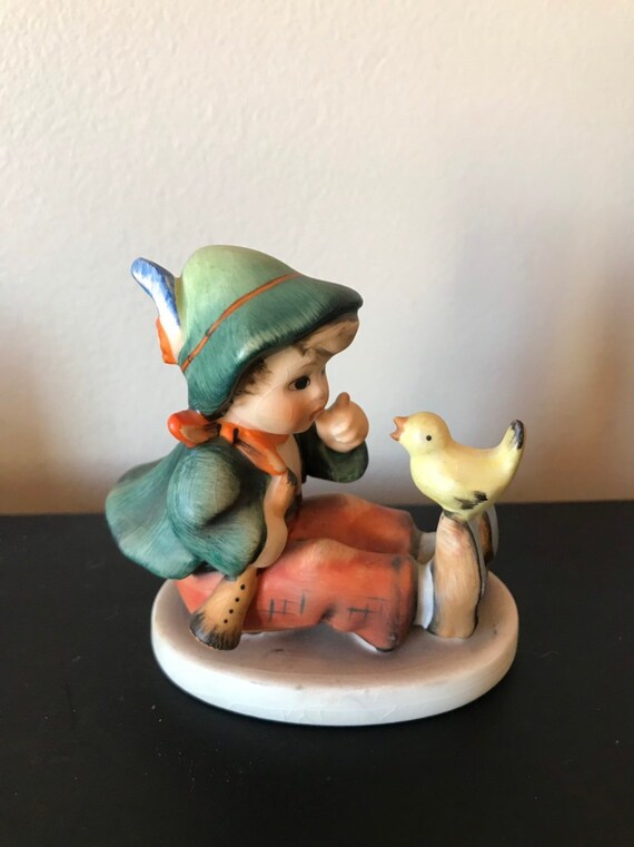 hummel boy with bird on foot