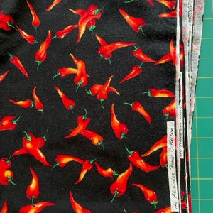 Alexander Henry Collection – red peppers on black background - sold by the half yard
