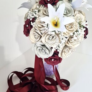 Teardrop book bridal bouquet with paper lilies, artificial gypsophila and trailing ribbons // The Courtney image 1