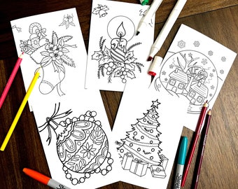 May include: Five black and white coloring pages featuring Christmas themes. The pages include a stocking with holly and berries, a candle with holly and berries, a Christmas tree with presents, a snow globe with houses and a tree, and an ornate Christmas ornament.