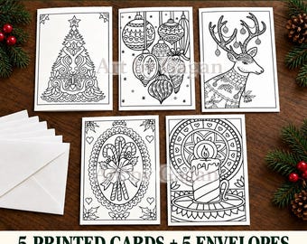 May include: Five white rectangular greeting cards featuring black line art designs for coloring, including a Christmas tree, ornaments, a reindeer, candy canes, and a candle. A stack of five white envelopes is included with the cards.