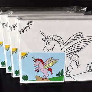 May include: A set of packaged coloring canvases featuring a winged unicorn design. Each canvas has a black outline of a unicorn, sun, and trees. A smaller, colored image of the unicorn is included. The canvases are packaged in clear plastic.