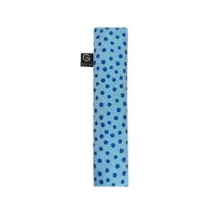 Puede incluir: Un objeto rectangular de tela en color azul claro con un patr&oacute;n de puntos azul oscuro. Una peque&ntilde;a etiqueta rectangular negra est&aacute; unida al lateral, mostrando el texto blanco GF y la palabra DREAM debajo en un tama&ntilde;o de fuente menor.