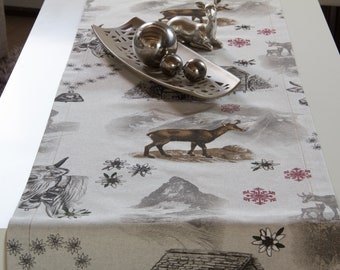 Table runners with alpine motifs with chamois, cows, mountains and mountain huts in different sizes
