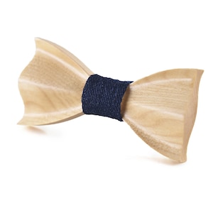 May include: A light brown wooden bow tie with a dark blue fabric band.