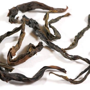 May include: Loose leaf black tea with long, dark brown, twisted leaves.
