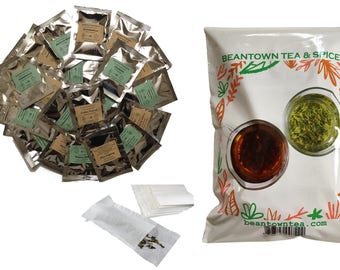 May include: A selection of tea products, including individual tea packets, tea bags, and a large bag of tea. The large bag is white with the text "BEANTOWN TEA & SPICES" and illustrations of tea. The individual packets are silver with various labels.