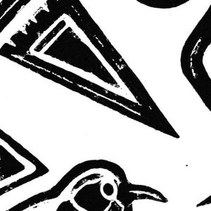 May include: Black and white linocut print featuring geometric shapes and a stylized bird. The design includes triangles and curved lines, creating a bold, graphic pattern. The print has a handmade, textured appearance.
