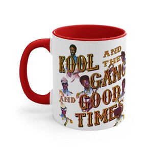 May include: White ceramic mug with a red interior and handle. The mug features a graphic of the band Kool & The Gang with the words "KOOL AND THE GANG GOOD TIMES" in a vintage style font.