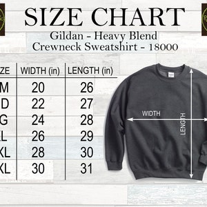 May include: A size chart for a Gildan Heavy Blend Crewneck Sweatshirt, model 18000. The chart shows measurements in inches for sizes SM to 3XL. The sweatshirt is dark grey, with white arrows indicating width and length.