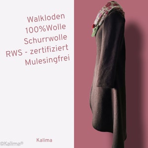 May include: A brown wool coat with a long, flowing hemline. The coat is made of 100% wool and is certified by the Responsible Wool Standard (RWS). The coat is also mulesing-free. The coat is shown hanging on a pink background with a floral scarf draped over the collar.