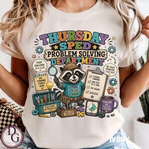 May include: A cream-colored t-shirt featuring a graphic of a raccoon wearing a hat and a blue shirt. The text reads THURSDAY SPED PROBLEM SOLVING DEPARTMENT, along with illustrations of a magnifying glass, a clipboard, a toolbox, and a mug.