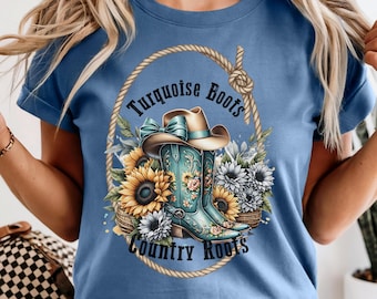 May include: A light blue t-shirt featuring a graphic design with a turquoise cowboy boot, a brown cowboy hat, sunflowers, and the text "Turquoise Boots Country Roots" inside a rope oval.