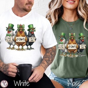May include: White and moss green t-shirts featuring a humorous graphic of three chickens wearing hats and sunglasses, each holding a sign with text. The text on the signs reads "I HAVE TO SAY...", "F-CAW-F...", and "...OR I'LL DIE."