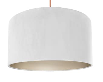 May include: A white velvet lampshade with a cream colored lining. The lampshade is round and has a smooth texture.