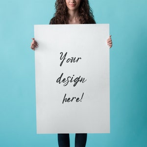 May include: A person holding a white poster with the text "Your design here!" written in black.