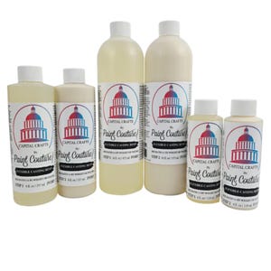 May include: A collection of six bottles of "Paint Couture" flexible casting resin. The bottles vary in size and contain a creamy, ivory-colored liquid. Each bottle has a white label with a red, white, and blue graphic of a building.