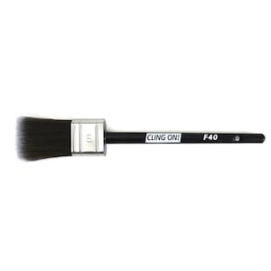 May include: A black and silver paint brush with a black handle and the text "CLING ON!" and "F40" printed on the handle. The brush is designed for painting.