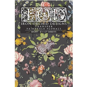 May include: A sheet of Iron Orchid Designs transfer paper with a dark gray background and a floral pattern. The paper is 8" x 12" and features the text "Fairytale Florals". The design includes pink, yellow, and purple flowers.