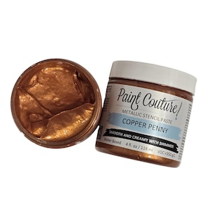 May include: A jar of Paint Couture metallic stencil paste in Copper Penny, with the lid off, revealing the smooth, shimmery paste. The label indicates it's water-based, 4 fl. oz. (118 ml).